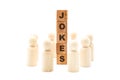 Wooden figures as business team in circle around word JOKES