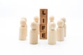 Wooden figures as business team in circle around word LIFE Royalty Free Stock Photo
