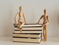 Wooden figures celebrating friendship on a books closed, culture bookday