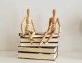 Wooden figures celebrating friendship on a books closed, culture bookday