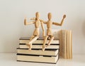 Wooden figures celebrating friendship on a books closed, culture bookday Royalty Free Stock Photo