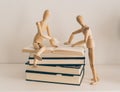 Wooden figures learning and teaching with books, culture and education