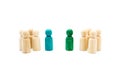 Wooden figures in line as business team, with blue and green figures standing out from the crowd, isolated on white background Royalty Free Stock Photo