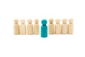 Wooden figures in line as business team, with one blue figure standing out from the crowd, isolated on white background Royalty Free Stock Photo