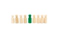 Wooden figures in line as business team, with one green figure standing out from the crowd, isolated on white background Royalty Free Stock Photo