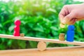 Wooden figures of a man and a woman stand on the scales and coins between them. concept of the gender pay gap. Income inequality.