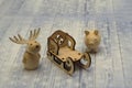 Wooden figures. New Year. Deer, pig and graceful sleigh on light background. Handmade