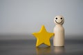 Wooden figures peg doll standing together with a yellow star. Talent, Human resources Royalty Free Stock Photo