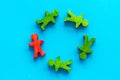 Wooden figures of people on blue background top view. Teamwork, teambuilding concept