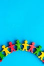 Wooden figures of people on blue background top view. Teamwork, teambuilding concept copy space