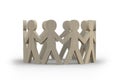 Wooden figures of people in a circle holding hands and standing Royalty Free Stock Photo