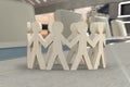 Wooden figures of people in a circle holding hands Royalty Free Stock Photo