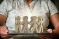 Wooden figures of people in a circle holding hands Royalty Free Stock Photo