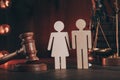 Wooden figures of people and gavel on a table. Family law concept Royalty Free Stock Photo