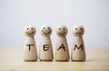 Wooden figures smile face with team wording on body for teamwork and business corporation concept