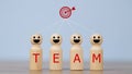 Wooden figures smile faces with team wording on the body and target icons. Teamwork and Ideas for business corporation concept.