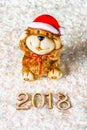 Wooden figures of 2018 on snow. Christmas atmosphere. The new year 2018. A toy dog is a symbol of the New Year. Royalty Free Stock Photo