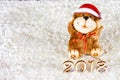 Wooden figures of 2018 on snow. Christmas atmosphere. The new year 2018. A toy dog is a symbol of the New Year. Royalty Free Stock Photo