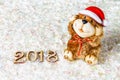 Wooden figures of 2018 on snow. Christmas atmosphere. The new year 2018. A toy dog is a symbol of the New Year. Royalty Free Stock Photo