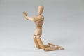 Wooden figurine kneeling with both hands joined Royalty Free Stock Photo