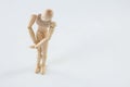 Wooden figurine with leg injured