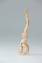 Wooden figurine performing a headstand Royalty Free Stock Photo