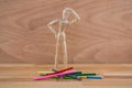 Wooden figurine selecting colour pencil