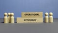 Wooden Figurines and Blocks Representing Operational Efficiency in Business Context Royalty Free Stock Photo