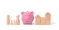 Wooden figurines of family, and pink piggy bank. Wooden figurines concept. model house on a white