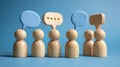 Wooden Figurines with Mixed-Material Speech Bubbles Representing Dialogue Royalty Free Stock Photo