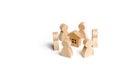 Wooden figurines of people stand around the house. Search for a new home and real estate. Buying or selling a home. Moving to a ne Royalty Free Stock Photo