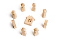 Wooden figurines of people stand around the house. Search for a new home and real estate. Buying or selling a home. Royalty Free Stock Photo