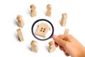 Wooden figurines of people stand around the house. Search for a Royalty Free Stock Photo