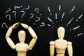Figurines question and exclamation marks as symbols of difficulties in communication