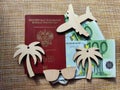 Wooden figurines, Russian passport, Euro banknotes. Concept of traveling and payment. Conflict of Russia and Ukraine