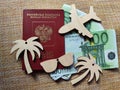 Wooden figurines, Russian passport, Euro banknotes. Concept of traveling and payment. Conflict of Russia and Ukraine