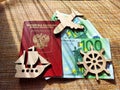 Wooden figurines, Russian passport, Euro banknotes. Concept of traveling and payment. Conflict of Russia and Ukraine