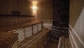 A wooden Finnish sauna is lit by light