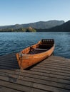 Wooden fisherboat canoe tourist paddle rowing watercraft at dock pier in lake Bled Blejsko Jezero Julian Alps Slovenia