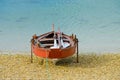 Wooden fishing boat dries on the seashore Royalty Free Stock Photo