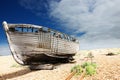Wooden fishing boat left to rot and decay on the shingle beach at Dungeness, England, UK. Royalty Free Stock Photo
