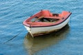 Wooden fishing boat with a motor anchored in the sea Royalty Free Stock Photo