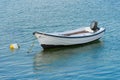 Wooden fishing boat with a motor anchored in the sea Royalty Free Stock Photo