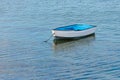 Wooden fishing boat with a motor anchored in the sea Royalty Free Stock Photo