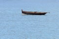 Wooden fishing boat with a motor anchored in the sea Royalty Free Stock Photo