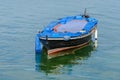 Wooden fishing boat with a motor anchored in the sea Royalty Free Stock Photo