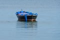 Wooden fishing boat with a motor anchored in the sea Royalty Free Stock Photo