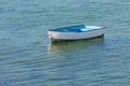 Wooden fishing boat with a motor anchored in the sea Royalty Free Stock Photo