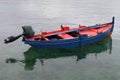 Wooden fishing boat with motor moored in the sea Royalty Free Stock Photo