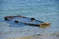 Wooden fishing boat submerged in water Royalty Free Stock Photo